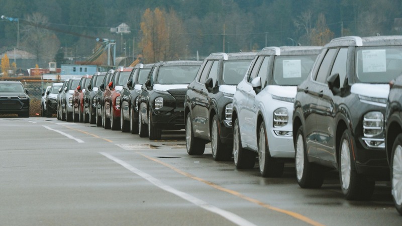 Fila de autos 0km sobre un camino, listos para su nacionalización